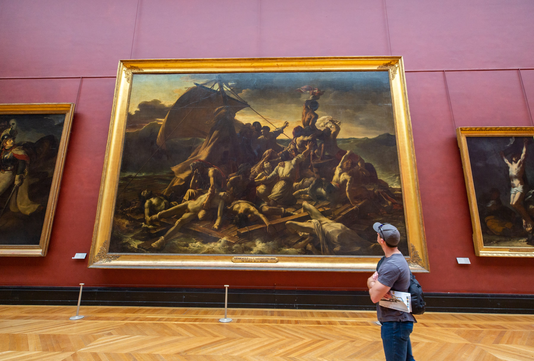 Man admiring the Raft of Medusa, Best things to see at the Louvre